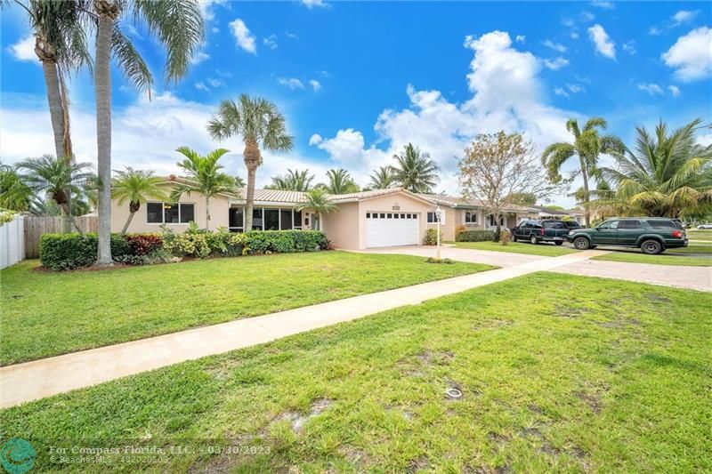 5206 Cleveland Street Hollywood, FL 33021 - Photo 33 of 49 a view of an house with swimming pool and trees in the background