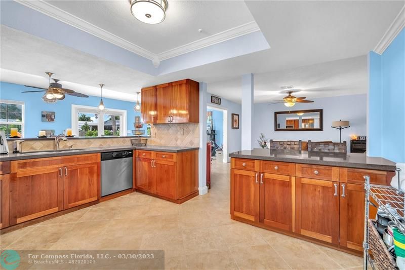 5206 Cleveland Street Hollywood, FL 33021 - Photo 40 of 49 a large kitchen with stainless steel appliances granite countertop a stove and a sink