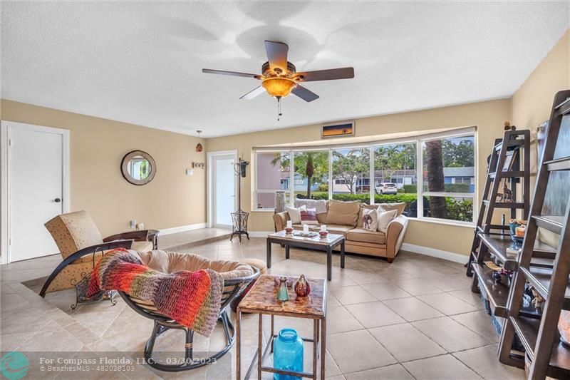 5206 Cleveland Street Hollywood, FL 33021 - Photo 49 of 49 a living room with furniture a rug and a floor to ceiling window