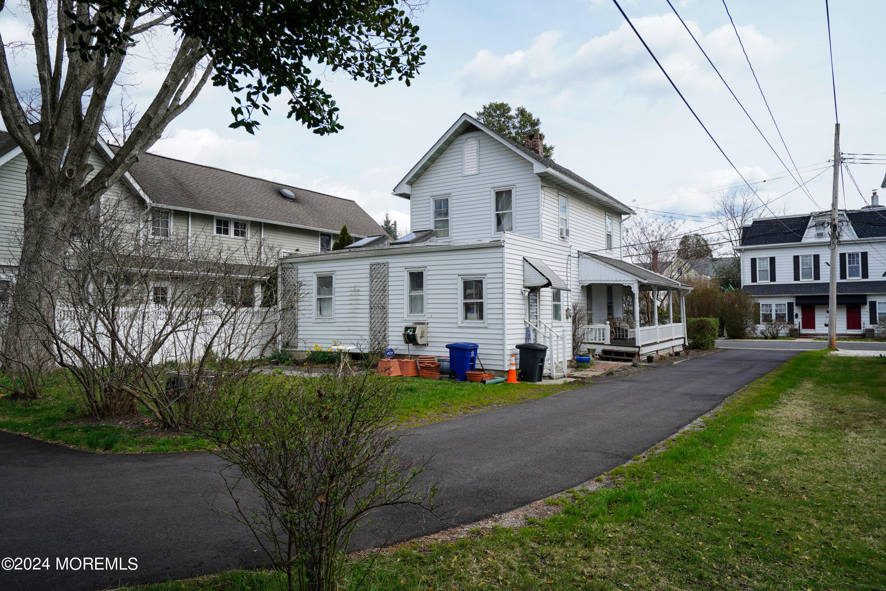 1719 Beverly Avenue Spring Lake Heights, NJ 07762 - Photo 8 of 21 a view of a white house with large trees and couches chairs