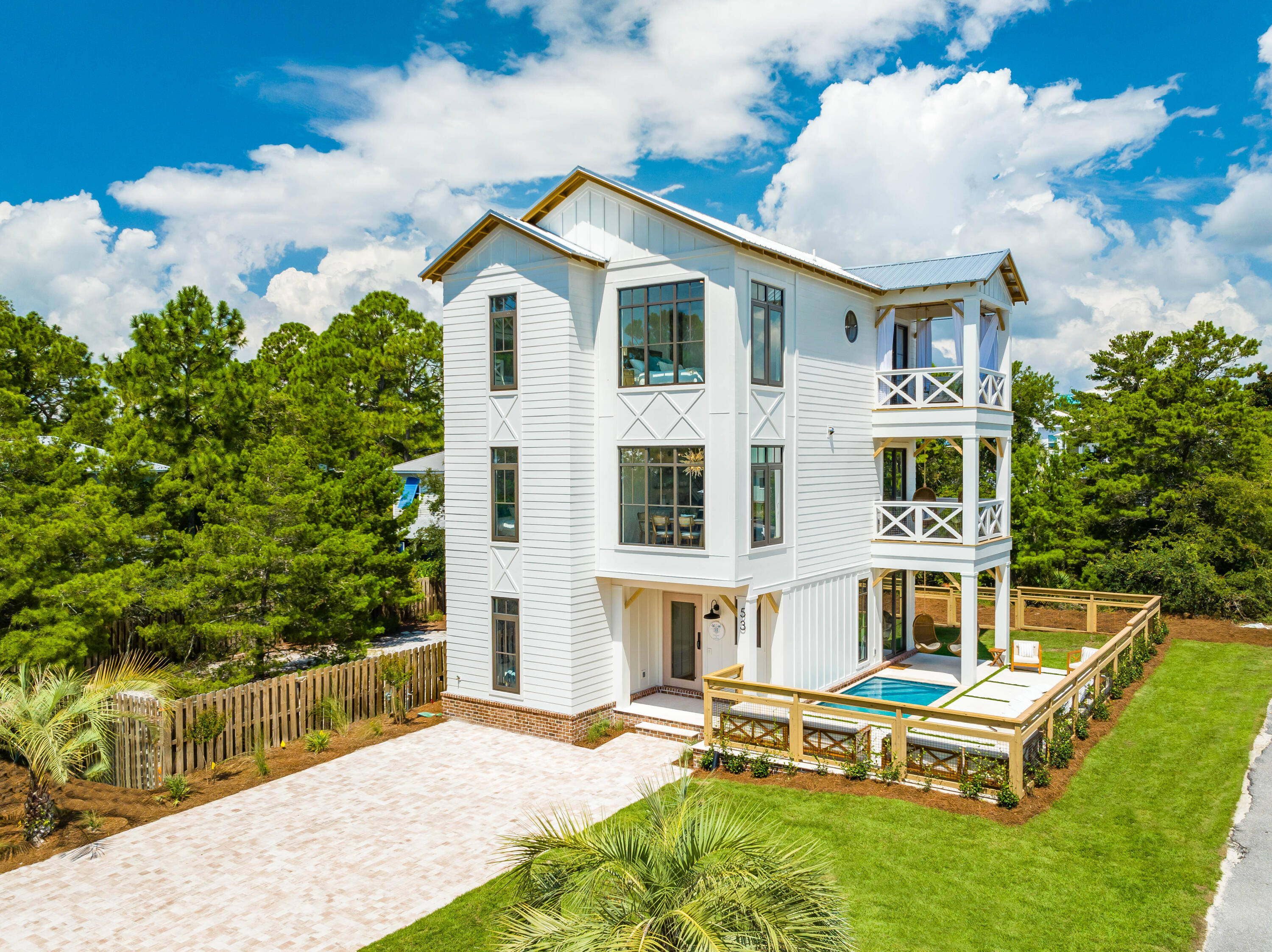 53 Porpoise Street Santa Rosa Beach, FL 32459 - Photo 13 of 75 a view of a house with a swimming pool and sitting area