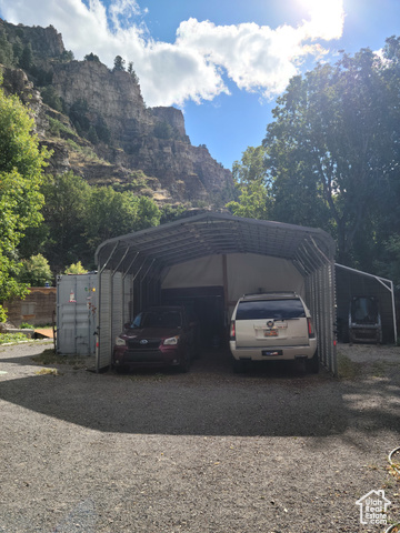 97 East Main Street Stockton, UT 84071 - Photo 22 of 58 View of car parking featuring a carport, driveway, and a mountain view