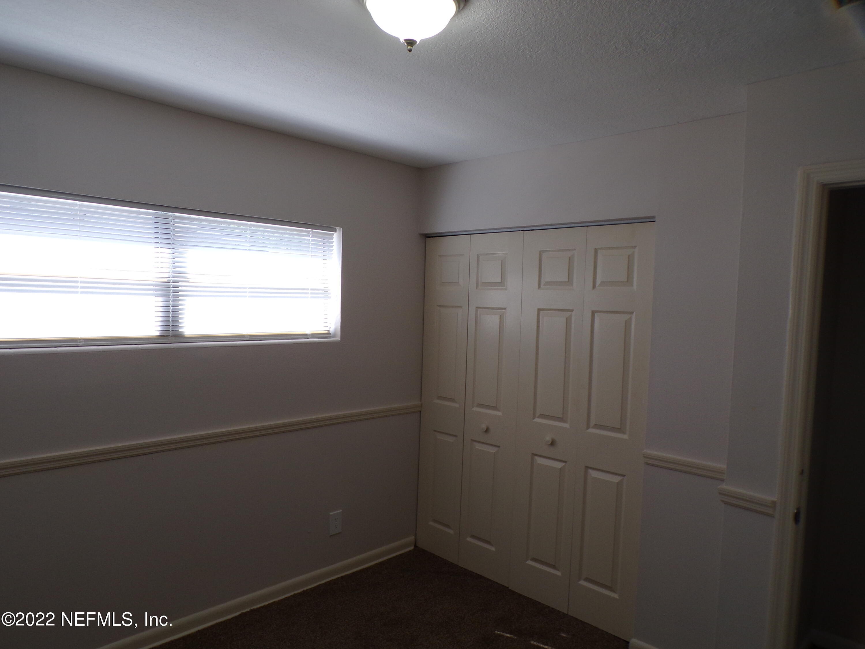 7424 Strato Road Jacksonville, FL 32210 - Photo 11 of 16 a view of an empty room with a window