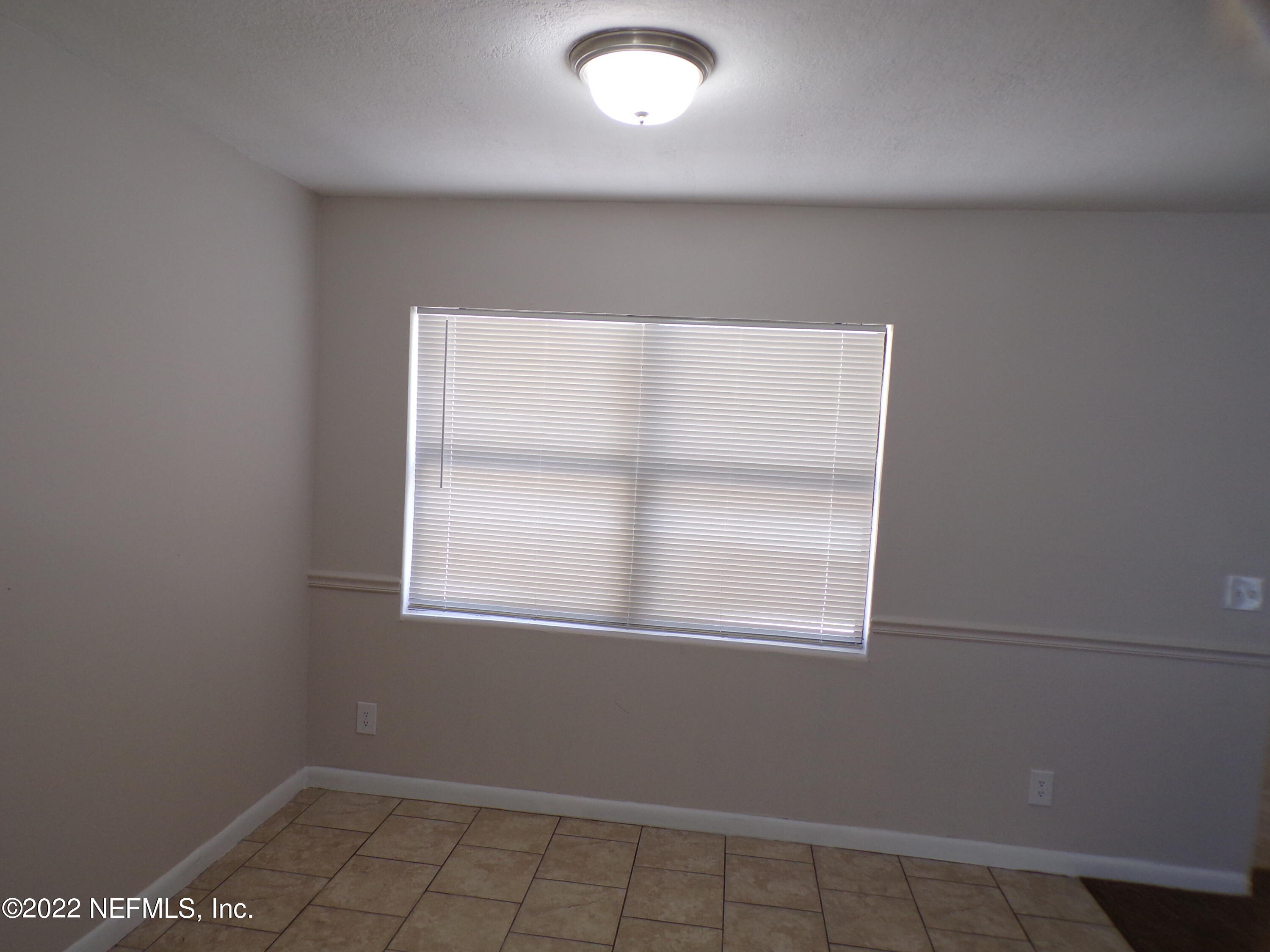 7424 Strato Road Jacksonville, FL 32210 - Photo 6 of 16 an empty room with a window