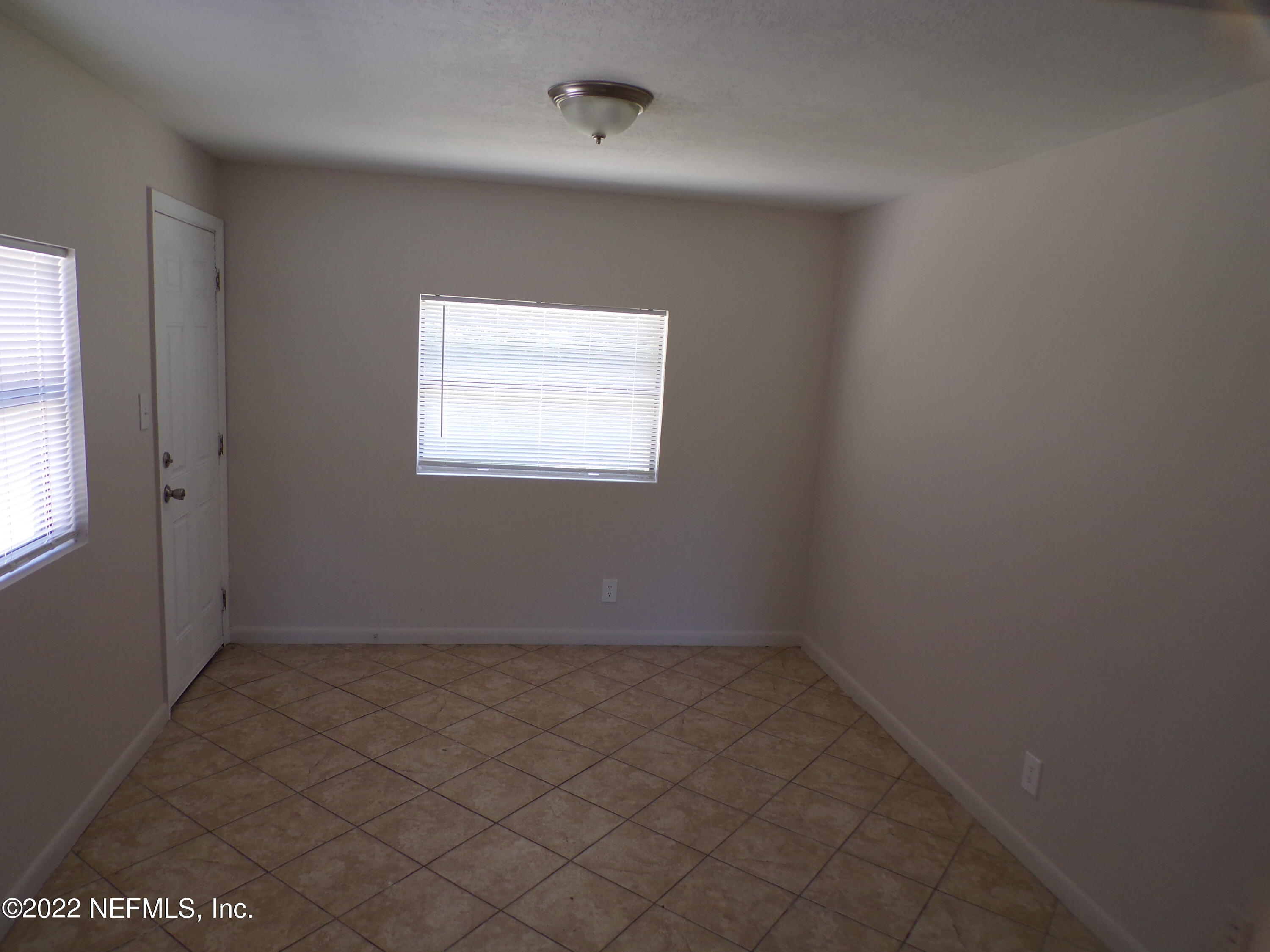 7424 Strato Road Jacksonville, FL 32210 - Photo 7 of 16 an empty room with a window