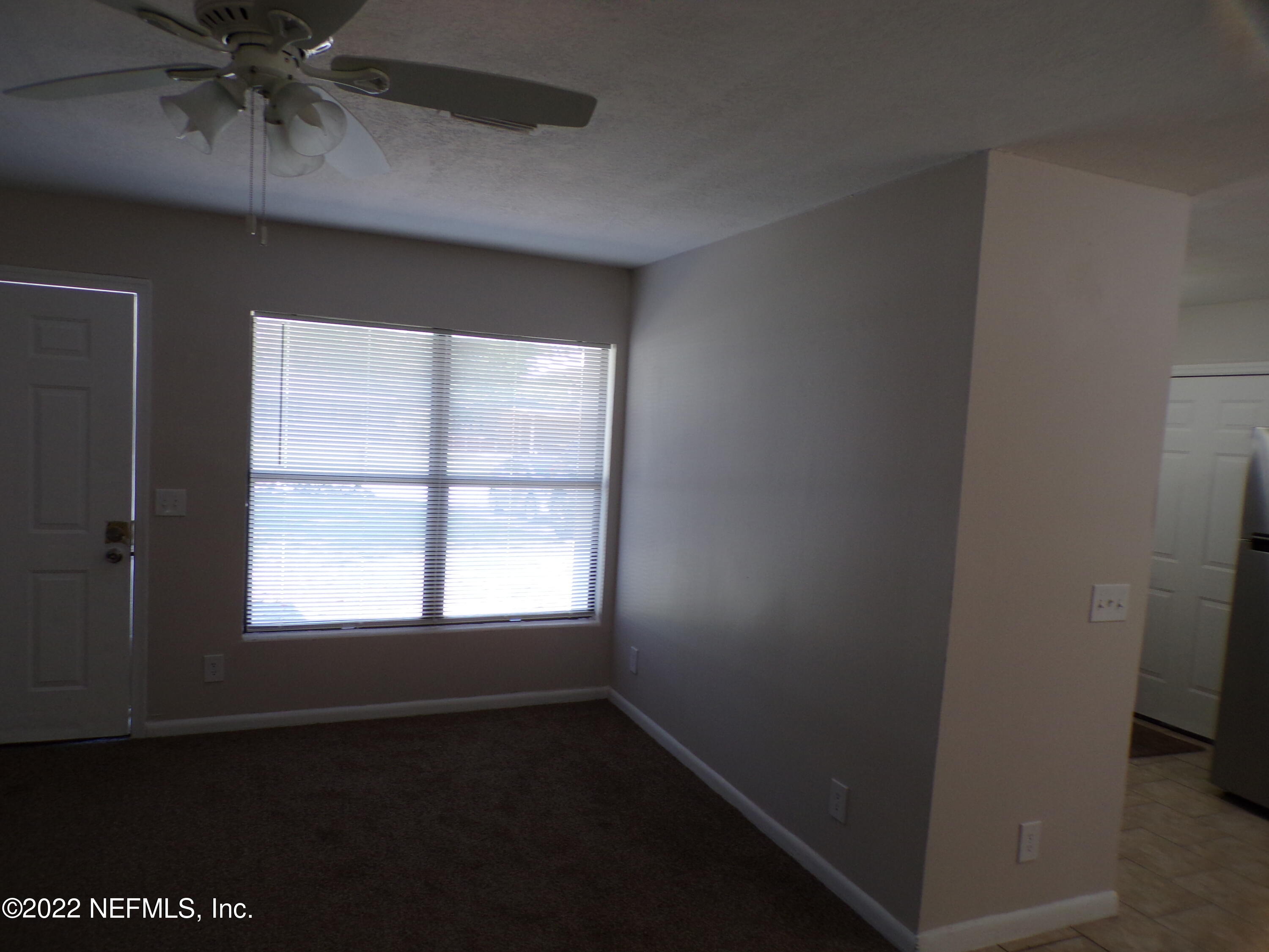 7424 Strato Road Jacksonville, FL 32210 - Photo 8 of 16 an empty room with a window