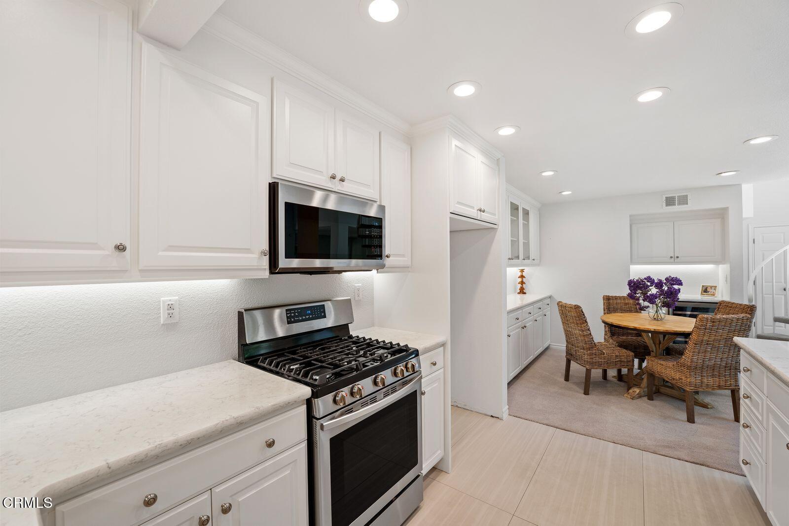 1941 Majorca Drive Oxnard, CA 93035 - Photo 10 of 39 a kitchen with a sink a stove and white cabinets