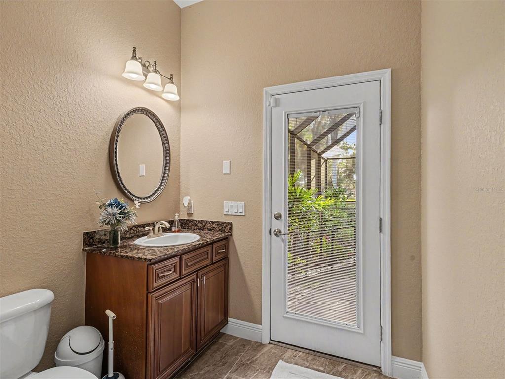 339 Corbett Road Lithia, FL 33547 - Photo 26 of 38 a bathroom with a toilet a sink and a mirror
