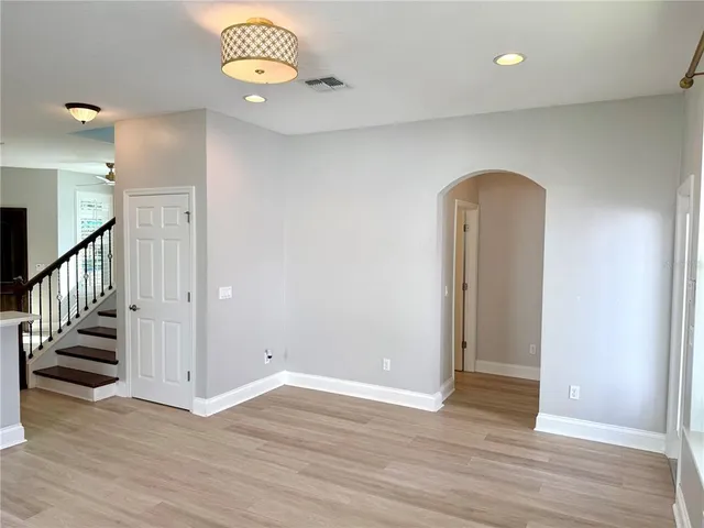 a view of an empty room and wooden floor