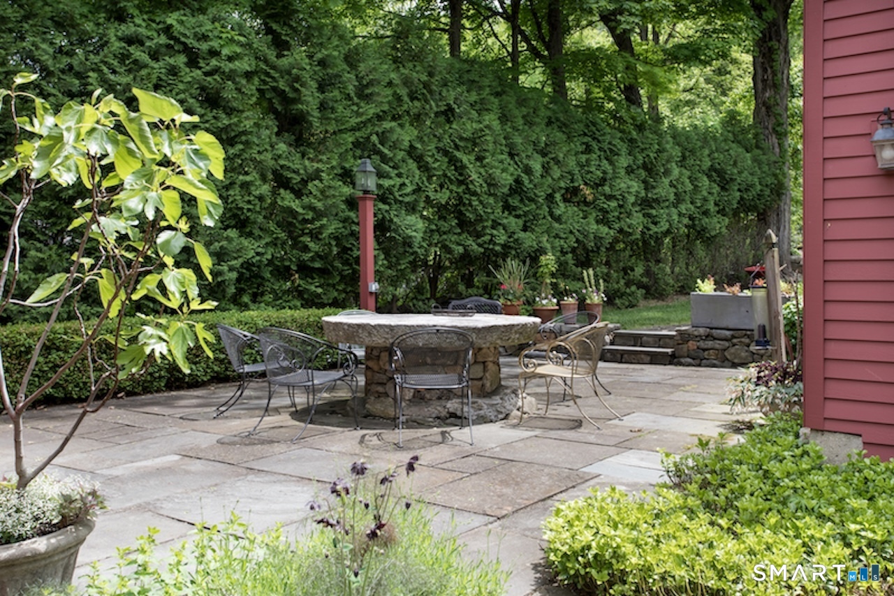3 Studio Hill Road Kent, CT 06757 - Photo 32 of 33 a view of a patio with table and chairs potted plants and large tree