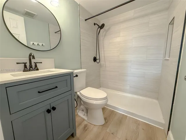 a bathroom with a sink a toilet and a mirror