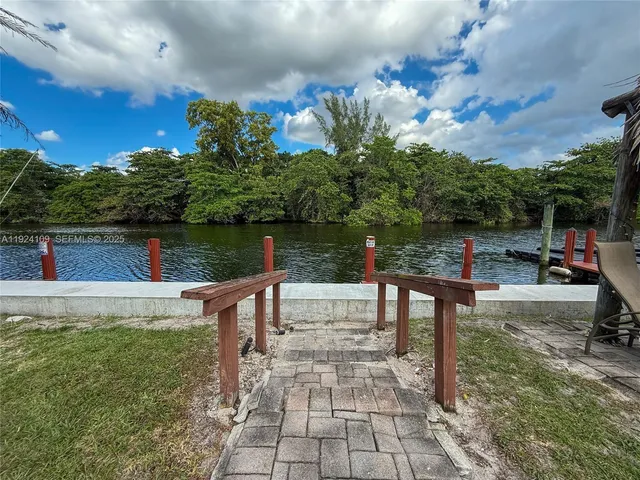 a view of a lake with tables and chairs