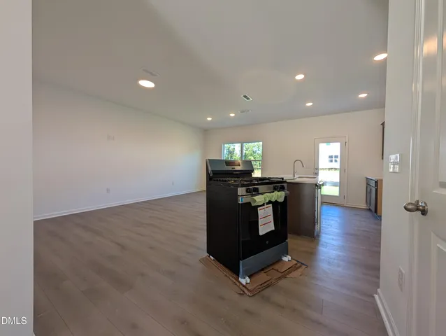 a living room with hard wood flooring and furniture
