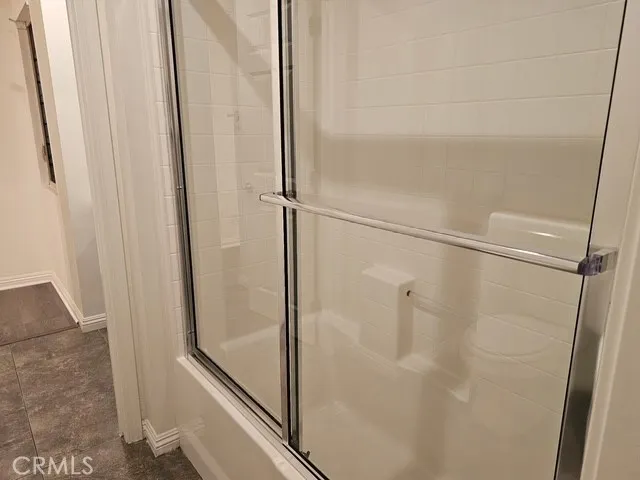 a bathroom with a glass shower door