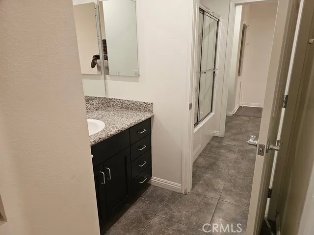 a bathroom with a granite countertop sink
