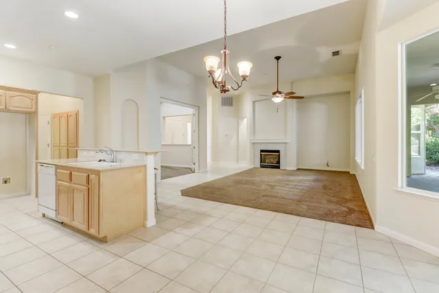 a view of kitchen with granite countertop cabinets and window