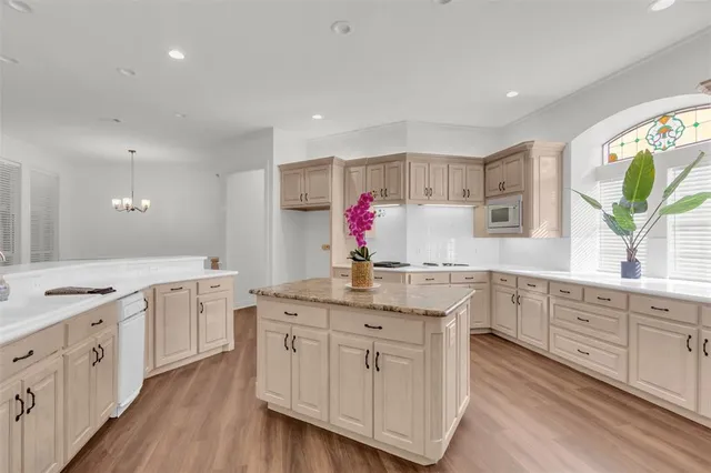 a kitchen with white cabinets and sink