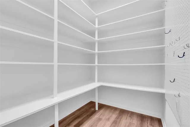 a view of walk in closet with empty racks