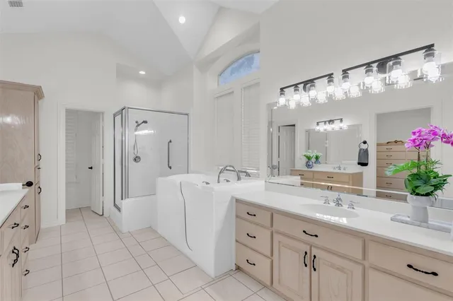 a spacious bathroom with a granite countertop sink mirror and shower