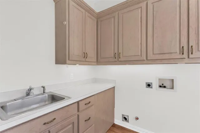 a bathroom with a sink and cabinets