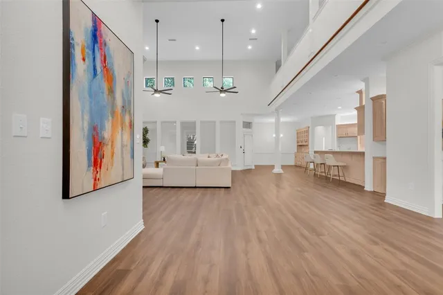 a living room with furniture and a kitchen view