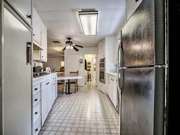 a kitchen with stainless steel appliances a stove sink and refrigerator