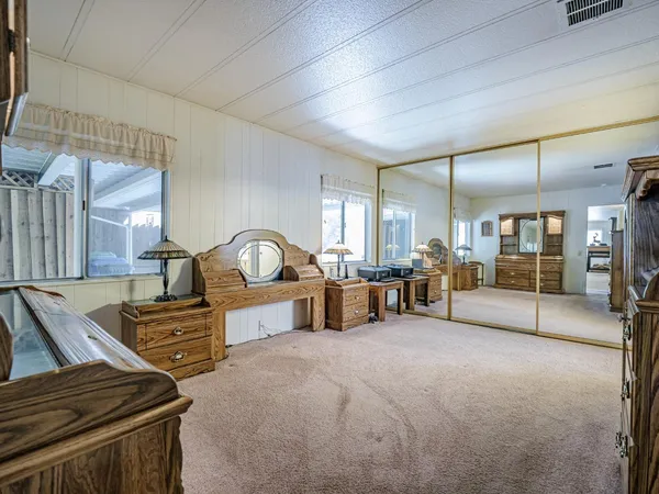 a bedroom with furniture and a flat screen tv