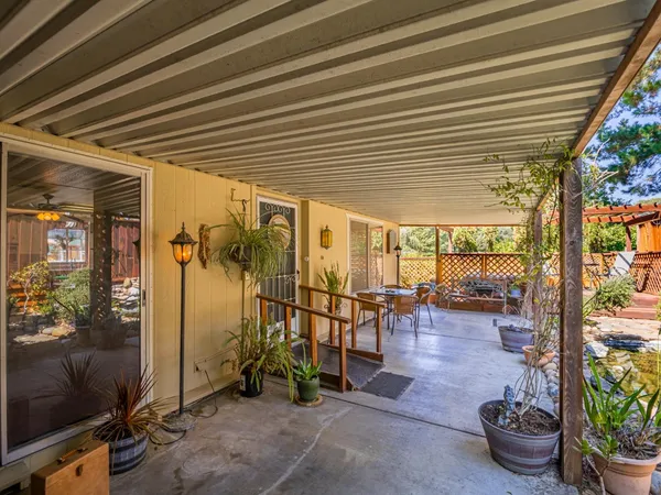 a view of a chairs and table in a backyard