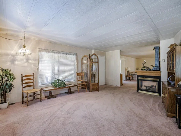 a view of a dining room with furniture and a chandelier