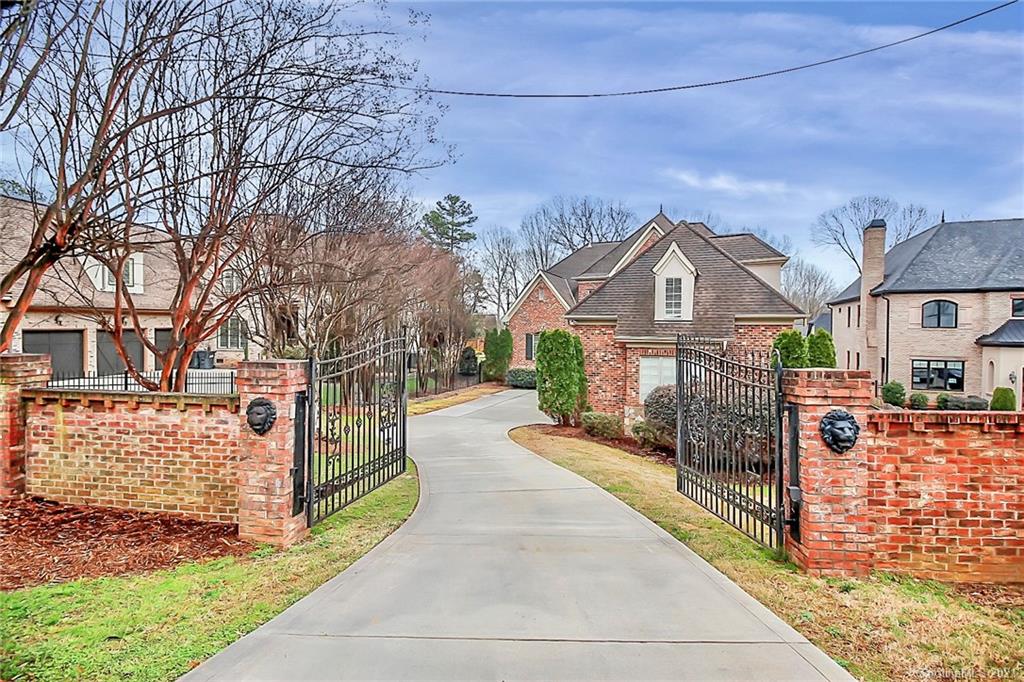6701 Sharon Road Charlotte, NC 28210 - Photo 2 of 47 a view of a house with a small yard and large tree