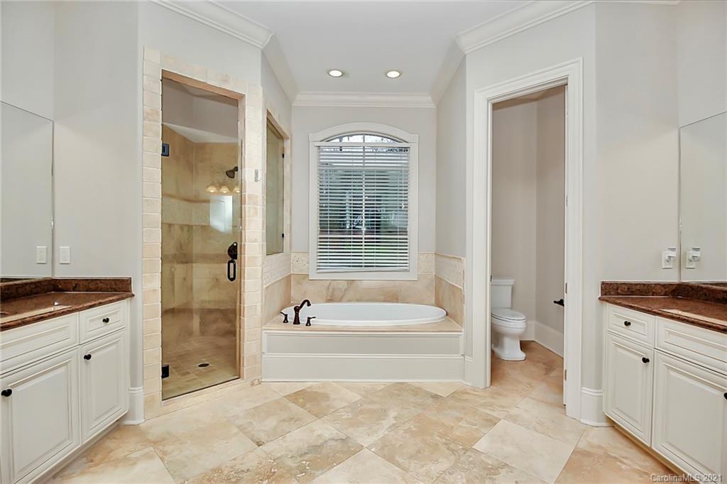 6701 Sharon Road Charlotte, NC 28210 - Photo 13 of 47 a spacious bathroom with a tub sink and mirror