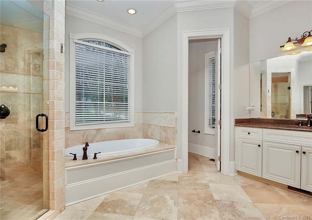 6701 Sharon Road Charlotte, NC 28210 - Photo 14 of 47 a bathroom with a tub sink and a mirror
