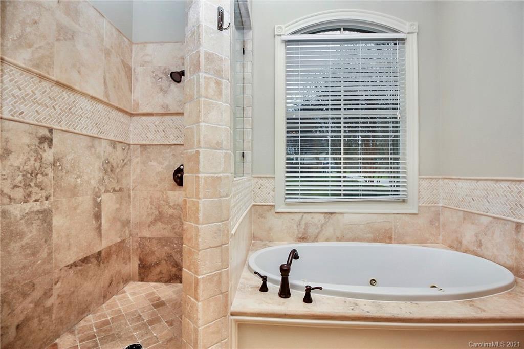 6701 Sharon Road Charlotte, NC 28210 - Photo 16 of 47 a bathroom with a tub