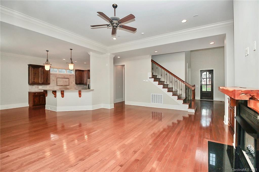 6701 Sharon Road Charlotte, NC 28210 - Photo 18 of 47 a view of a livingroom with furniture wooden floor and a kitchen view
