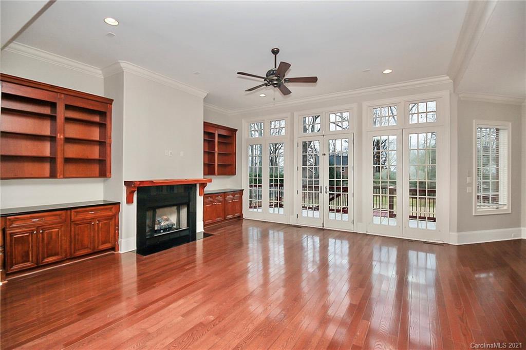 6701 Sharon Road Charlotte, NC 28210 - Photo 20 of 47 a view of wooden floor fire place and windows in a room