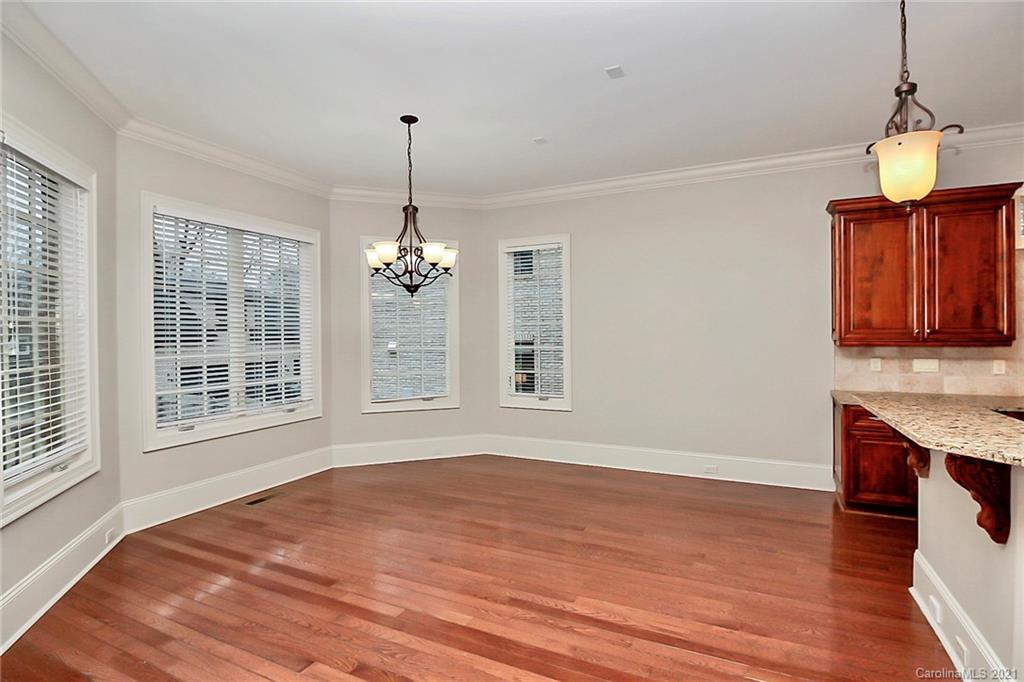6701 Sharon Road Charlotte, NC 28210 - Photo 21 of 47 a view of an empty room with wooden floor and a window