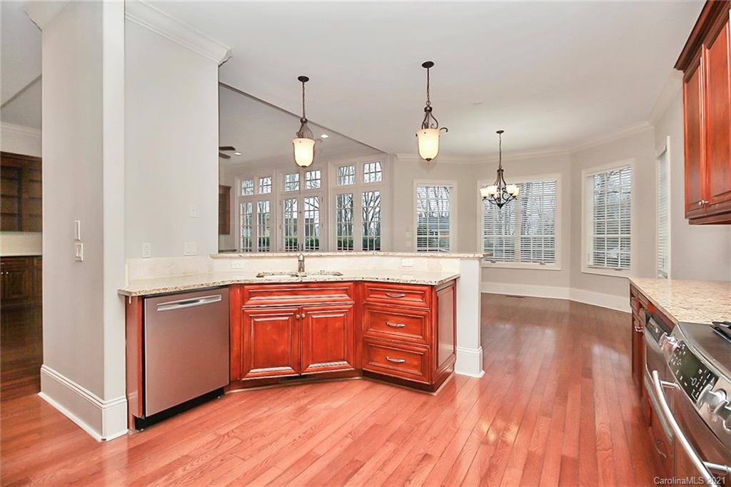 6701 Sharon Road Charlotte, NC 28210 - Photo 23 of 47 a large kitchen with granite countertop a large counter top space a sink and stainless steel appliances