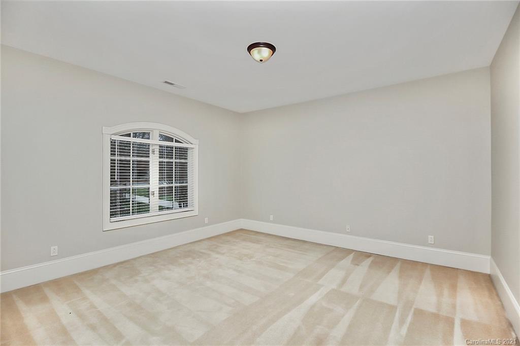 6701 Sharon Road Charlotte, NC 28210 - Photo 29 of 47 a view of an empty room with a window