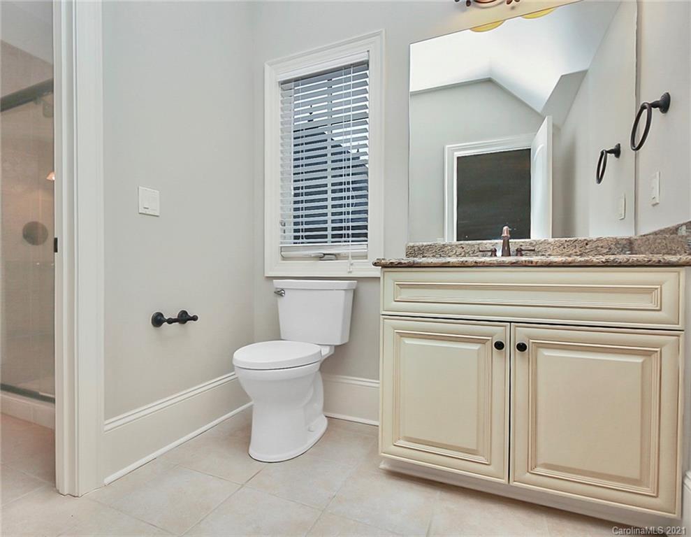 6701 Sharon Road Charlotte, NC 28210 - Photo 31 of 47 a bathroom with a toilet sink and mirror