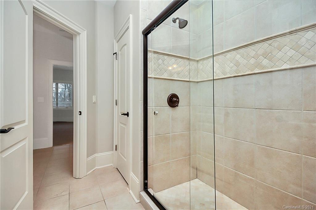 6701 Sharon Road Charlotte, NC 28210 - Photo 32 of 47 a bathroom that has a glass shower door