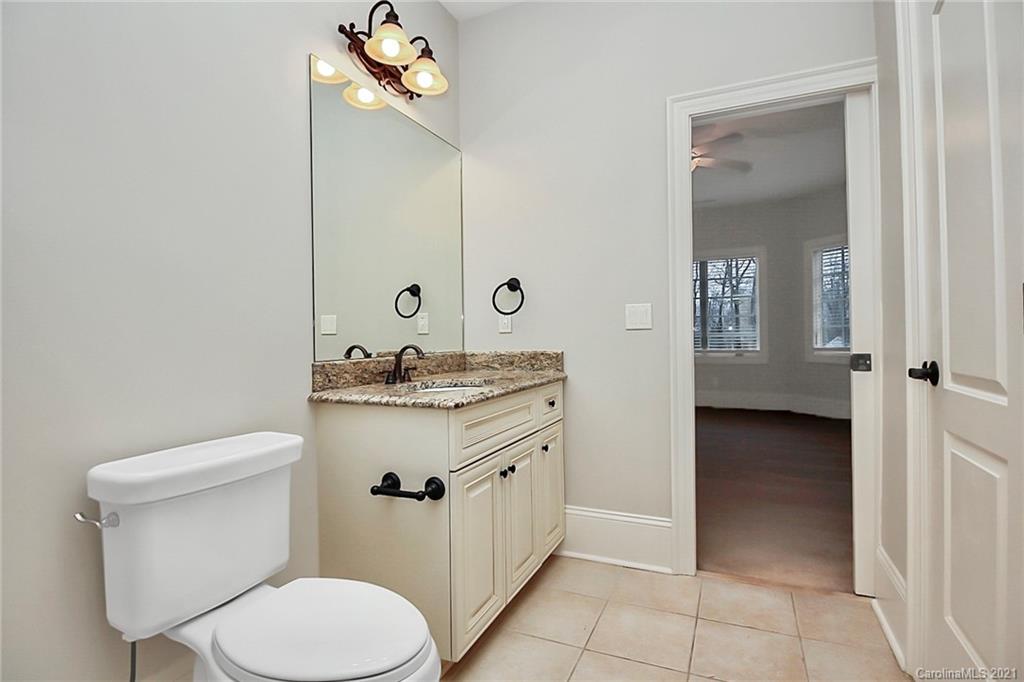 6701 Sharon Road Charlotte, NC 28210 - Photo 33 of 47 a bathroom with a sink a toilet and mirror