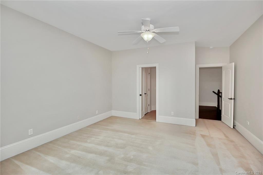 6701 Sharon Road Charlotte, NC 28210 - Photo 35 of 47 a view of an empty room with a chandelier fan