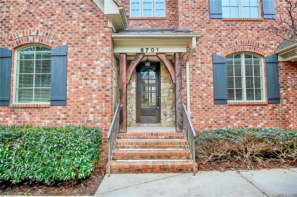 6701 Sharon Road Charlotte, NC 28210 - Photo 5 of 47 a front view of a house with a garden