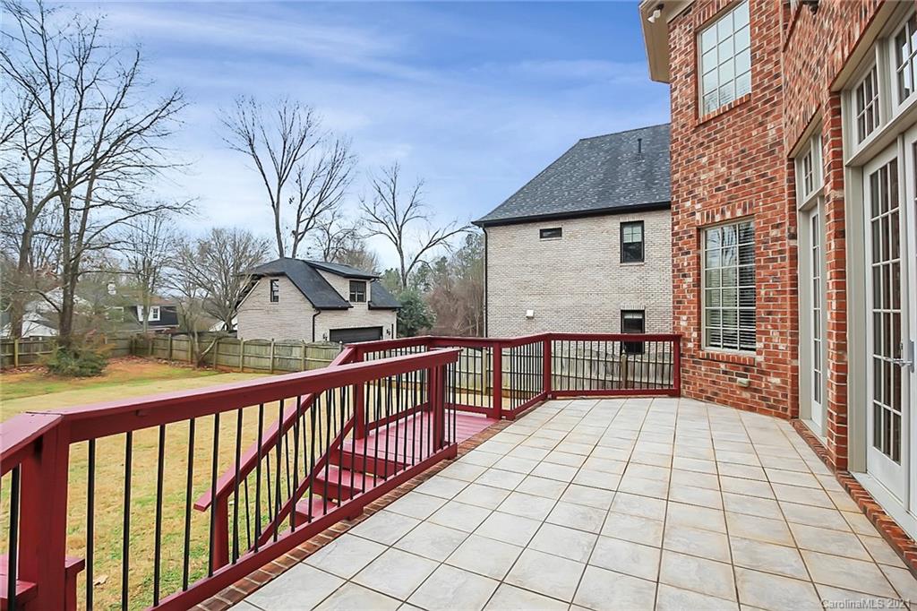 6701 Sharon Road Charlotte, NC 28210 - Photo 46 of 47 a view of a house with a large window and wooden fence