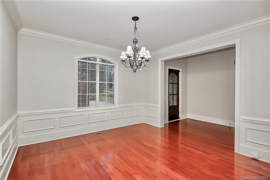 6701 Sharon Road Charlotte, NC 28210 - Photo 6 of 47 a view of empty room with wooden floor and fan