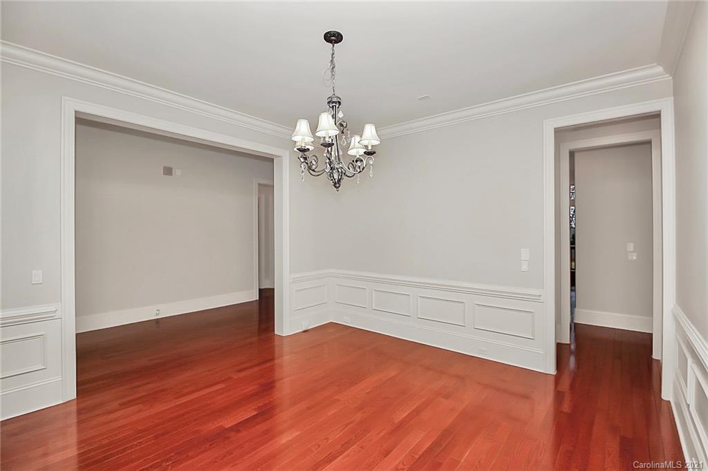 6701 Sharon Road Charlotte, NC 28210 - Photo 7 of 47 a view of a room with wooden floor and ceiling fan