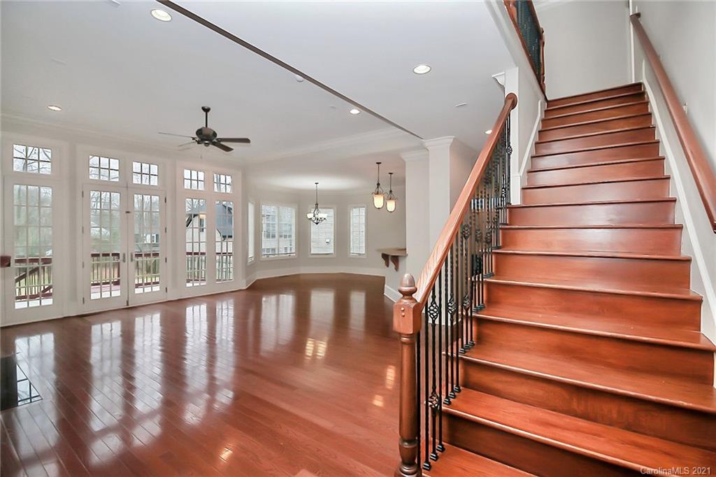 6701 Sharon Road Charlotte, NC 28210 - Photo 8 of 47 a view of staircase with railing and a chandelier