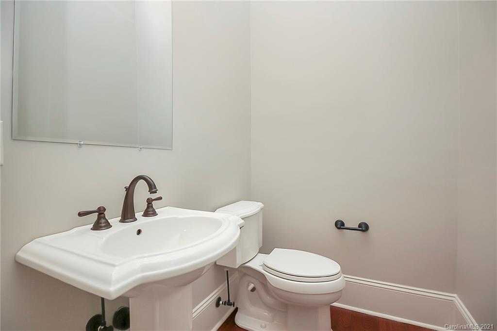 6701 Sharon Road Charlotte, NC 28210 - Photo 9 of 47 a white toilet sitting next to a white sink