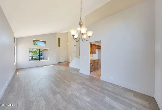 a kitchen with stainless steel appliances granite countertop a sink a stove and refrigerator