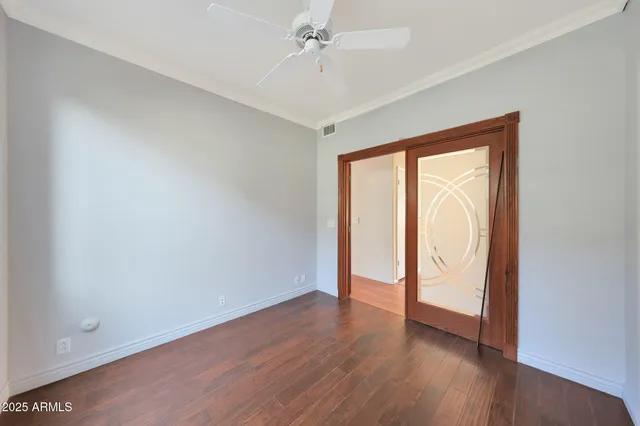 a view of a room with a ceiling fan